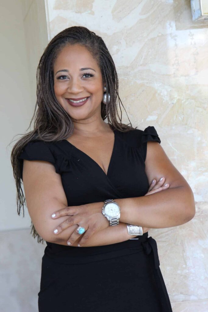 Donna Bohana Luxury Realtor Donna Bohana luxury Realtor professional headshot with arms crossed and smiling against a neutral background